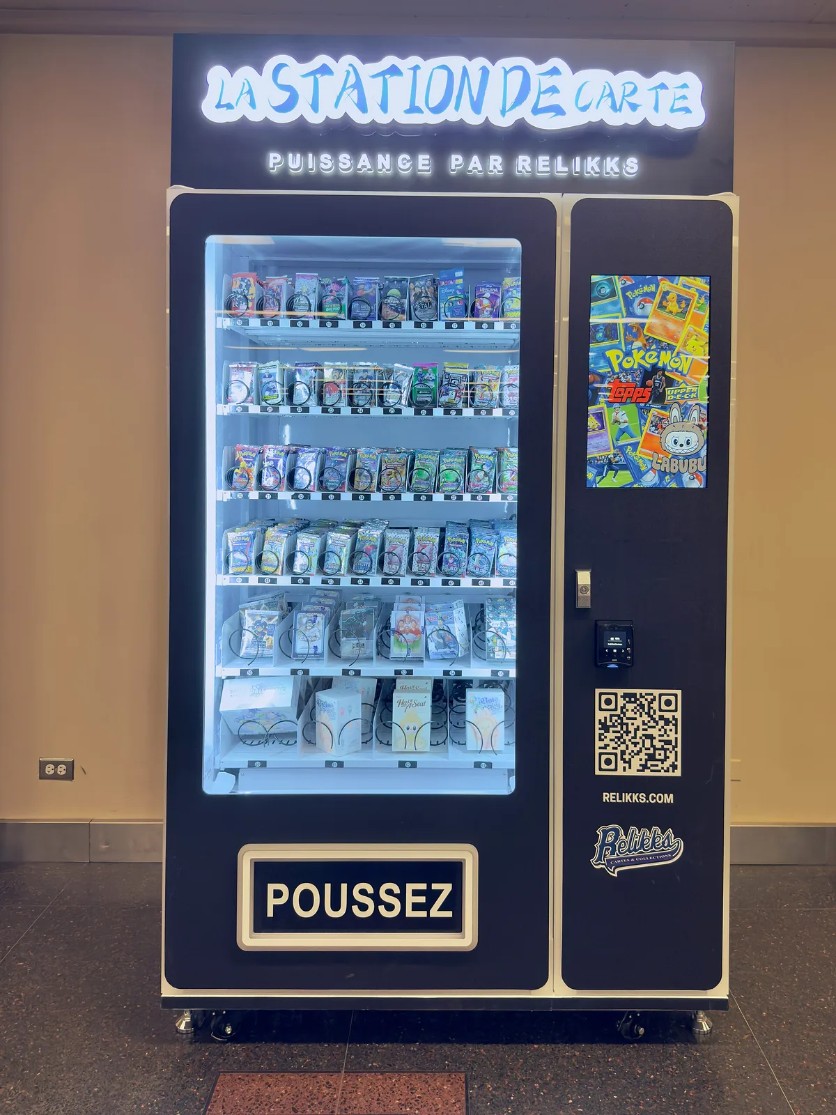 A trading card vending machine stocked with sealed card products at Montreal Central Station.