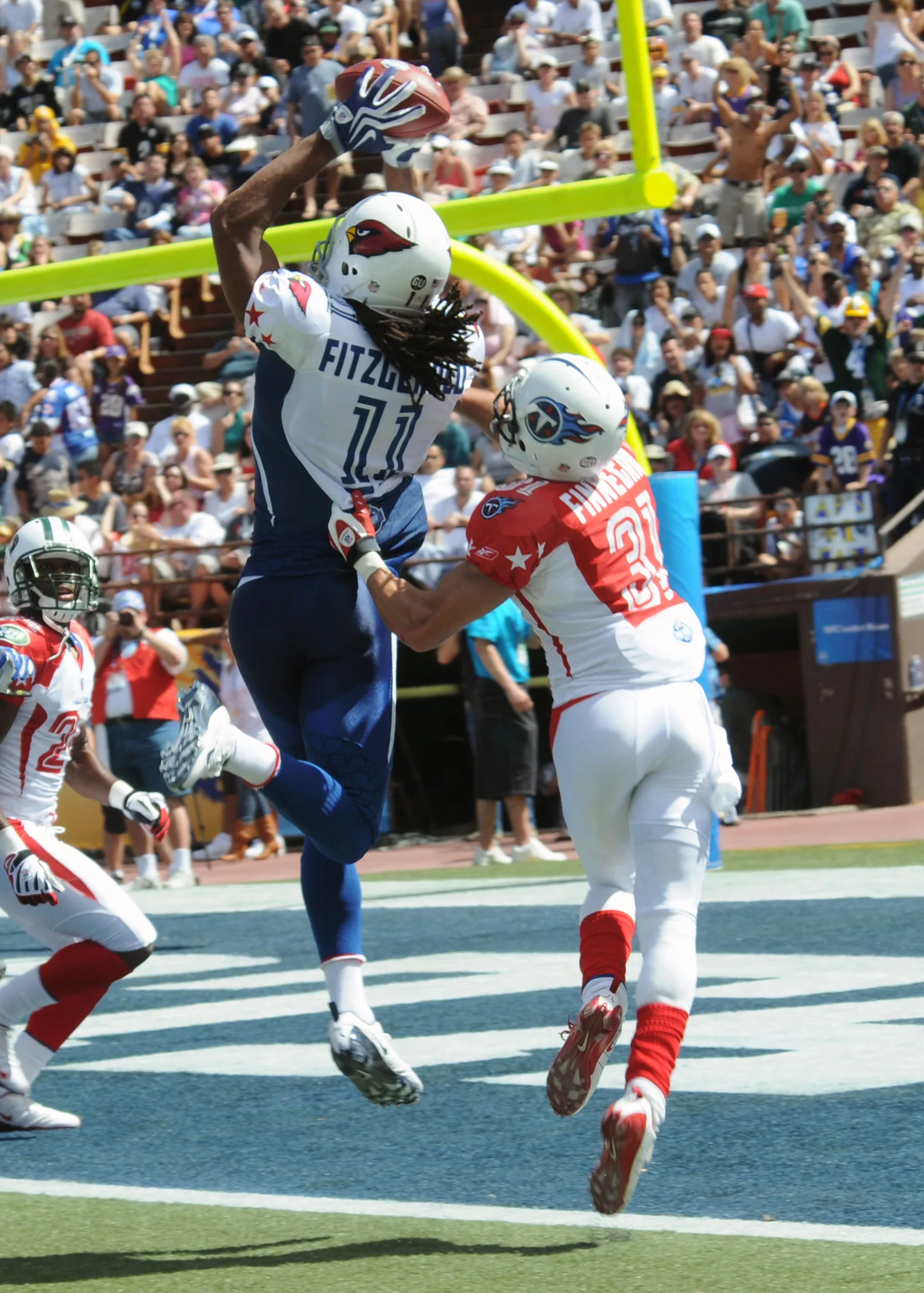 A wide receiver leaps above a defender to catch a touchdown pass at the 2009 Pro Bowl.