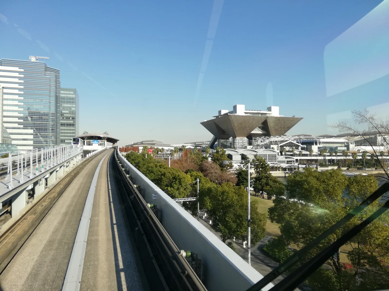 Tokyo Big Sight's distinctive inverted-pyramid towers seen from an elevated train line in Ariake, Tokyo.