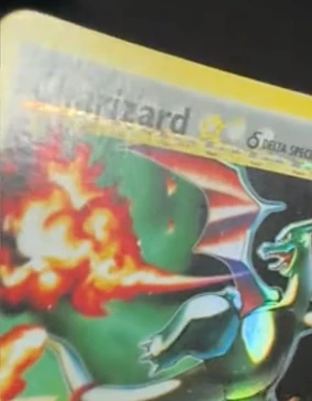 The same holographic Charizard trading card after CardRevive crease reduction, with the crease line no longer apparent