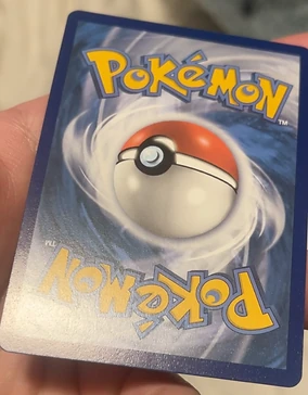 Pokemon card back after CardRevive edge repair, with the blue border reading clean and even