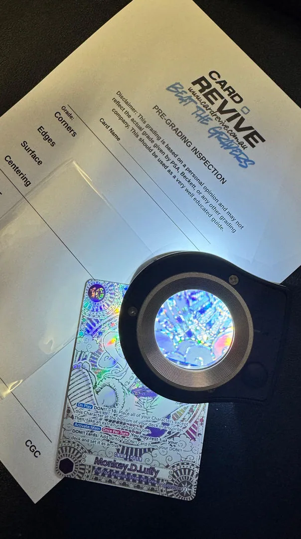 CardRevive pre-grading inspection sheet under a magnifier